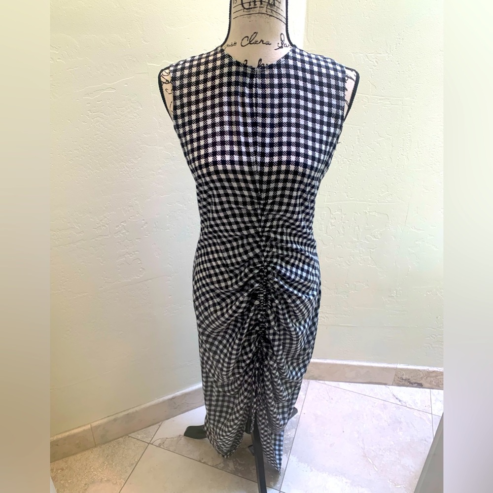 Woman’s check pattern, black, and white dress with gathering in the bottom